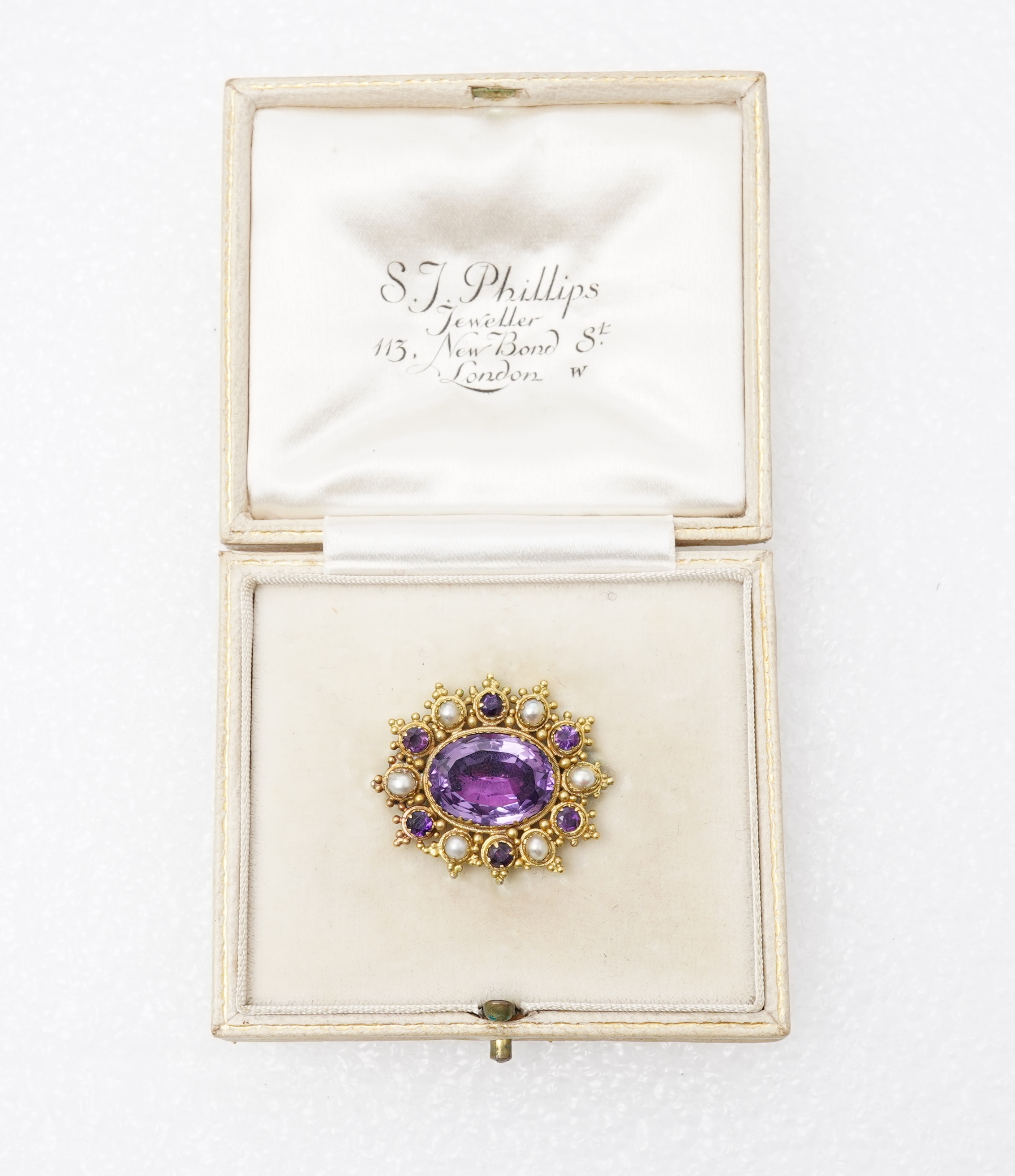 An amethyst and split pearl brooch, mid 19th century